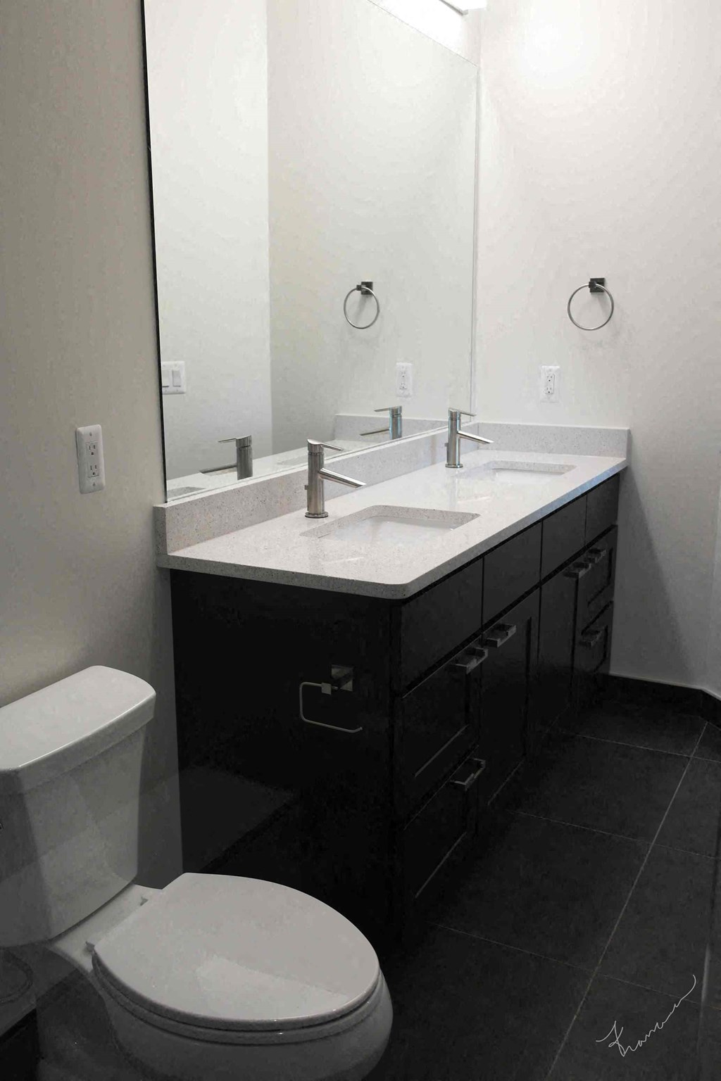 a bathroom with a toilet and a sink and a mirror
