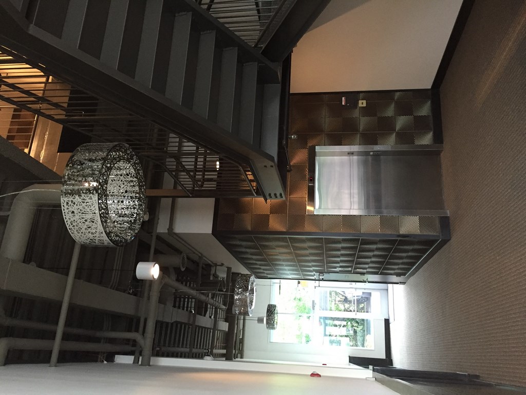 a view of the lobby of a building with a chandelier