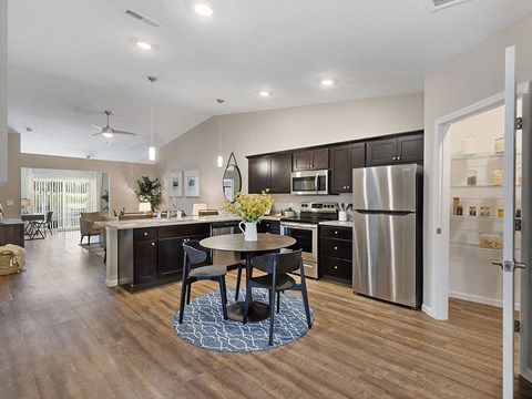 a kitchen with stainless steel appliances and a table