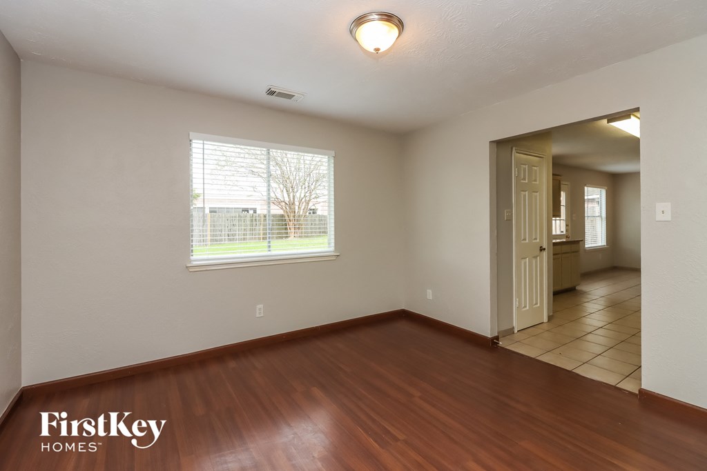 the living room and dining room of an empty house