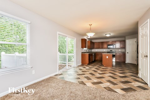 A living room with a checkered floor and a sliding glass door.