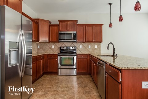 a kitchen with wooden cabinets and stainless steel appliances