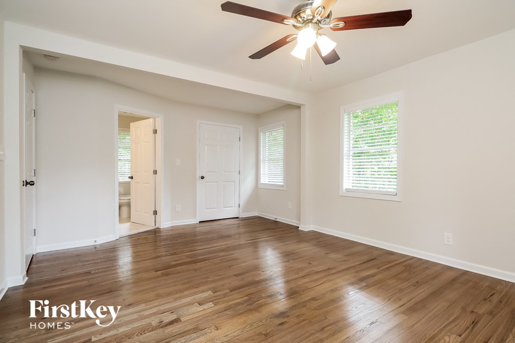 a living room with hardwood floors and a ceiling fan