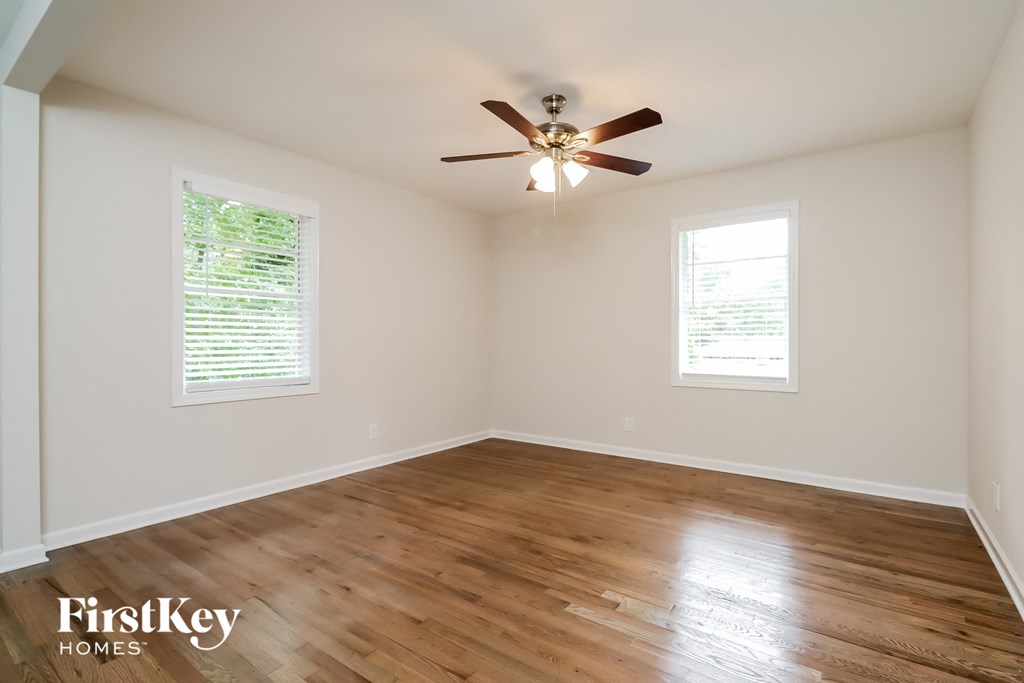 a living room with hardwood floors and a ceiling fan