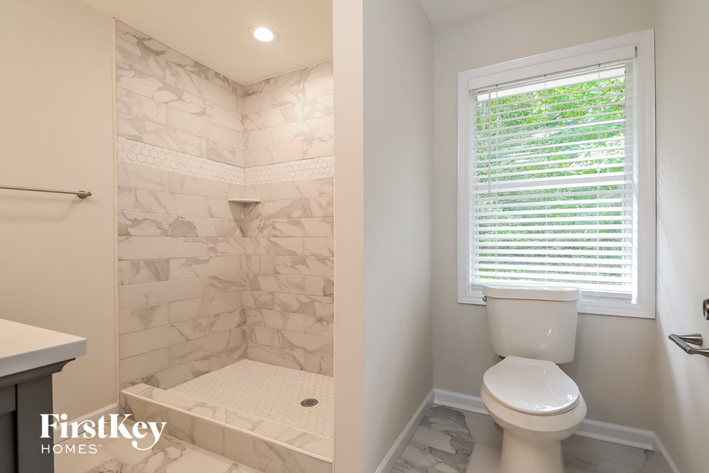 a small bathroom with a toilet and a shower