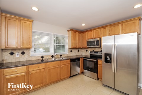 a kitchen with wooden cabinets and stainless steel appliances