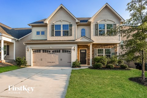 a large house with a garage door in front of it
