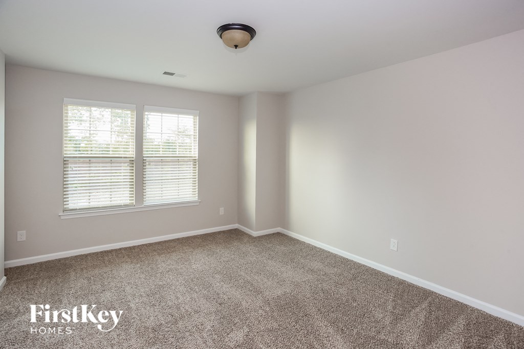 an empty room with carpet and a window