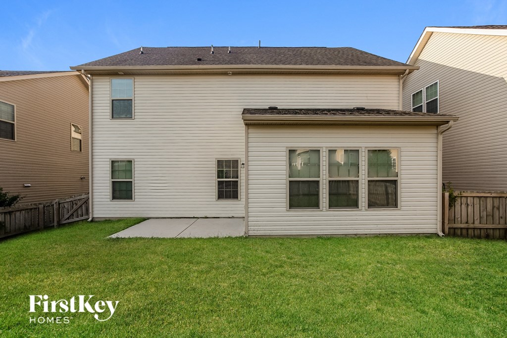 a white house with a yard in front of it