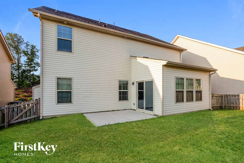 a white house with a yard in front of it