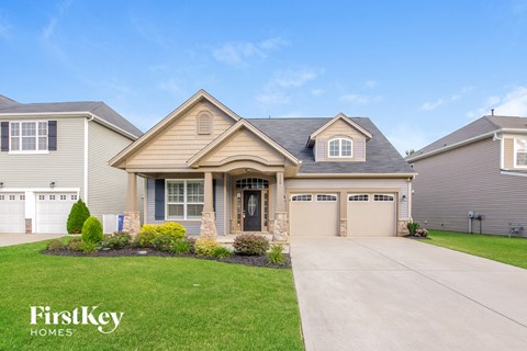 a house with a driveway and a lawn
