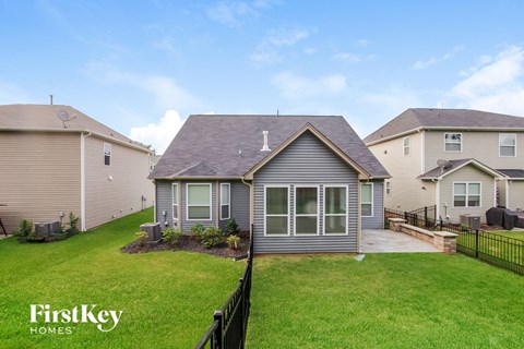 a small house with a yard and a grassy yard