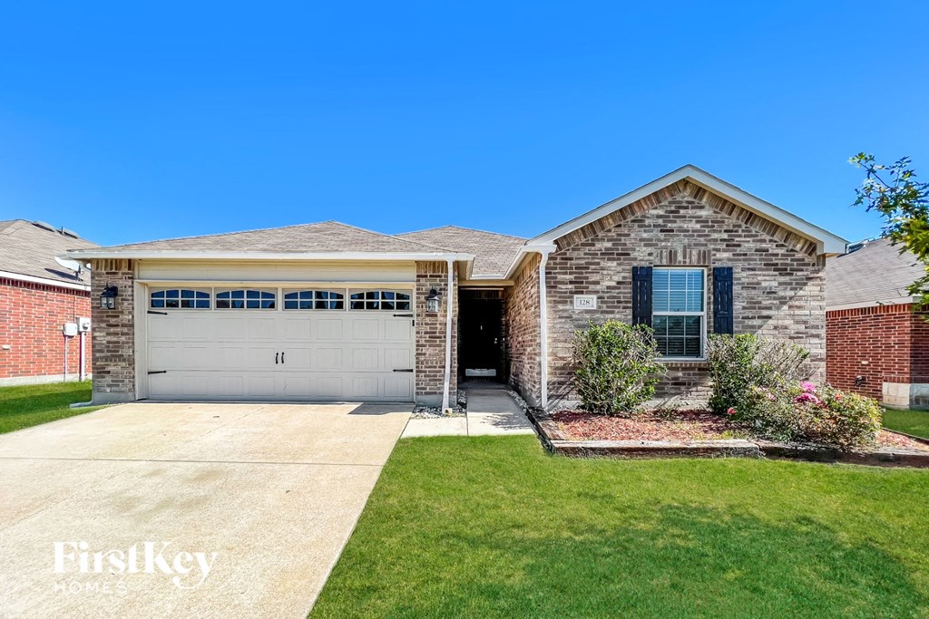 a brick house with a white garage door