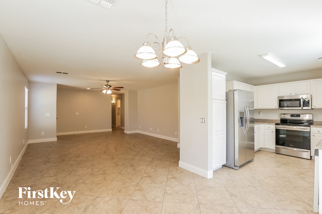 A kitchen area with a refrigerator, oven, and microwave.