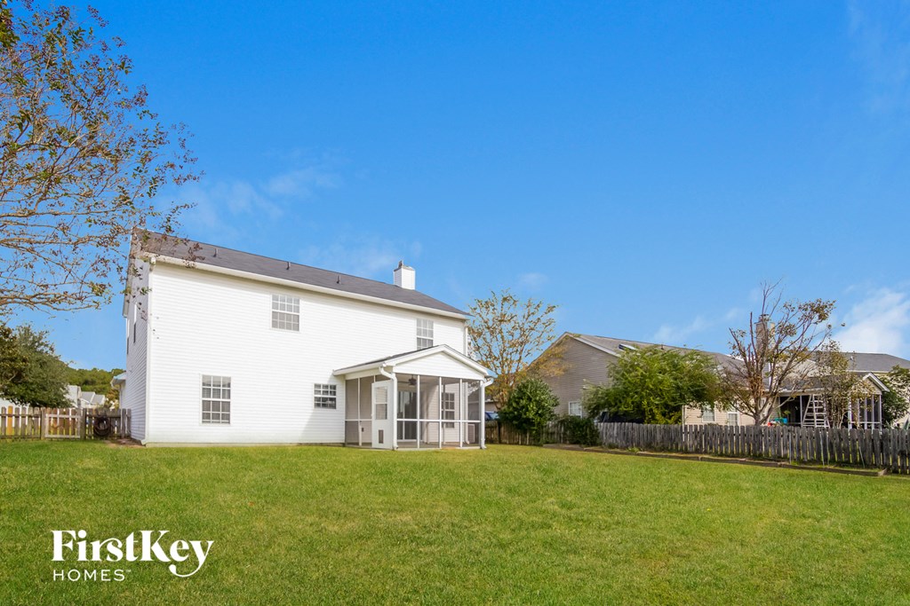 a white house with a yard in front of it