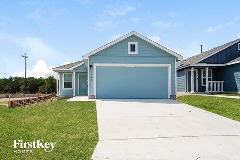 a blue house with a driveway and a blue garage door