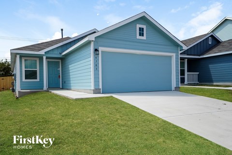 a blue house with a driveway and a blue garage door