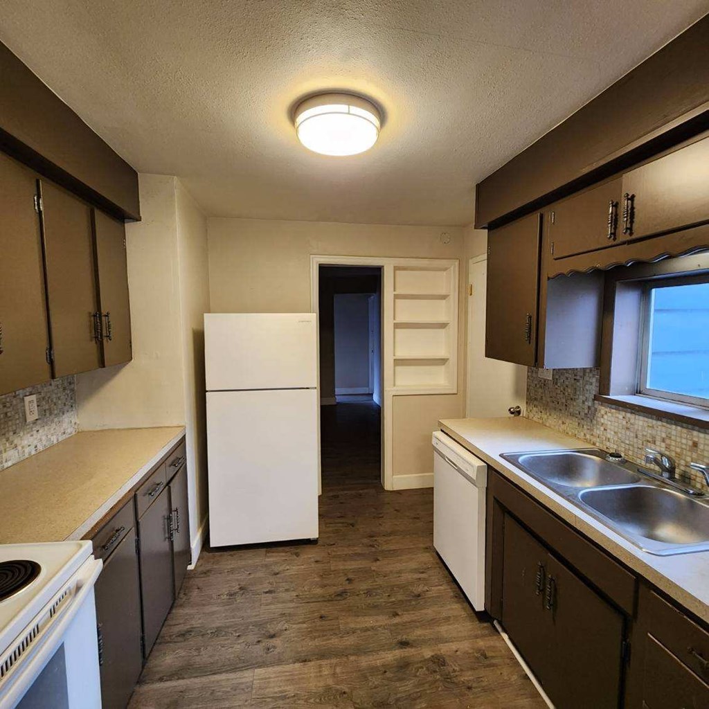 a kitchen with a sink and a refrigerator