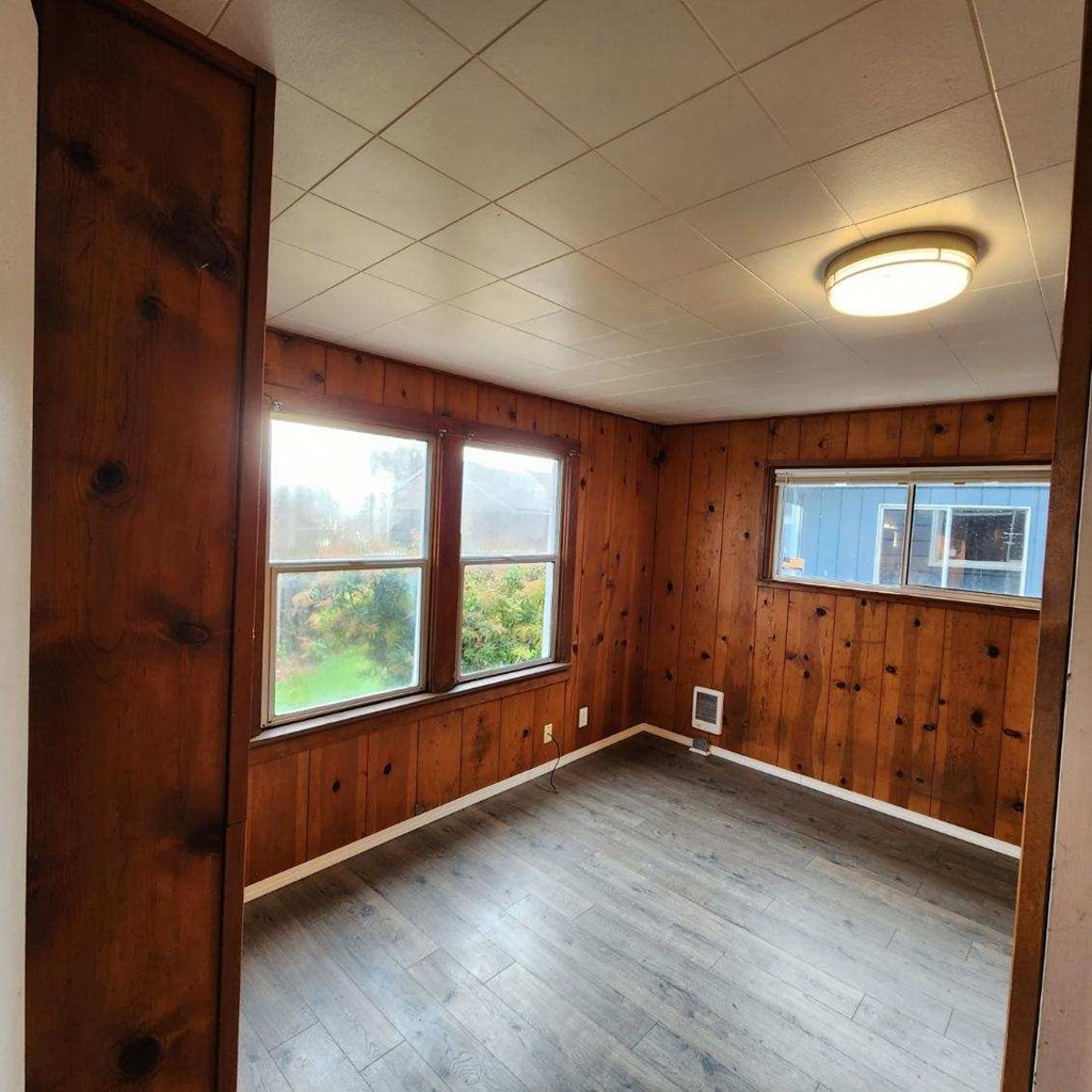 an empty room with wooden walls and a wooden floor