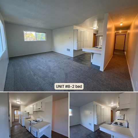 A bedroom with a bed, a desk, and a window.