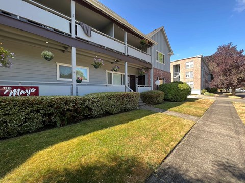 A building with the sign "The May" on the side of it.