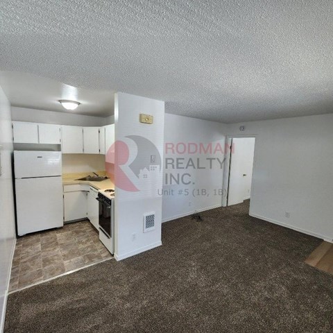 A room with Rodman Realty Inc. sign on the wall.