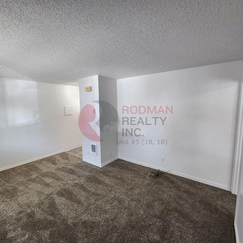 A room with Rodman Realty Inc. written on the wall.
