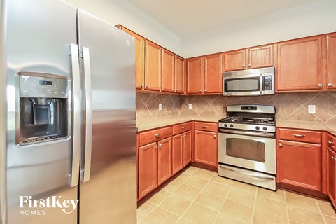a kitchen with wooden cabinets and stainless steel appliances