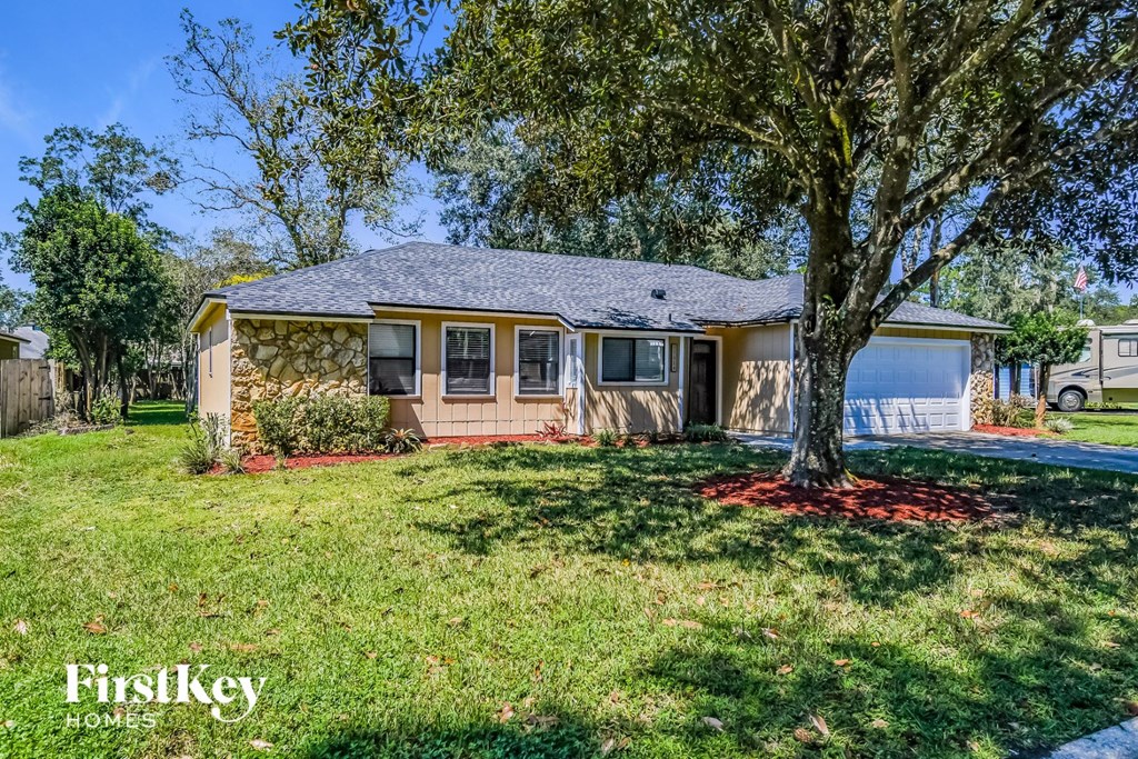 A house with a tree in front of it.