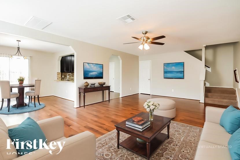 A living room with a couch, a coffee table, and a television.
