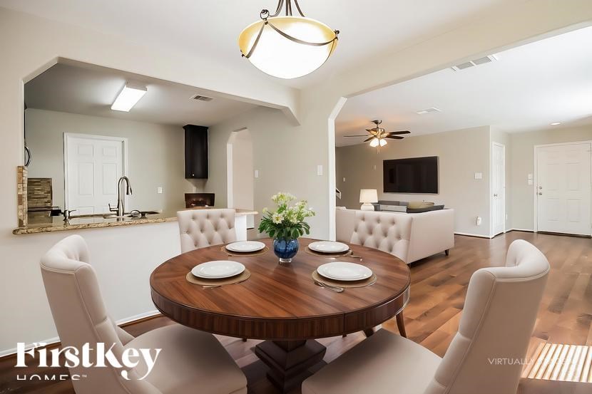 A dining room with a wooden table and chairs.