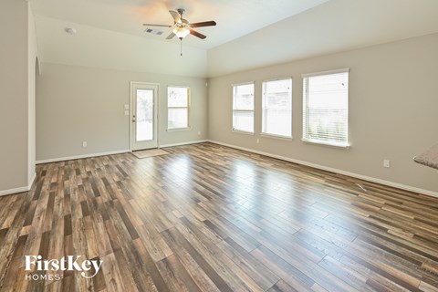 the living room with hardwood floors and a ceiling fan
