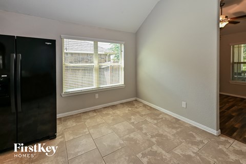 the living room has a large window and tile flooring