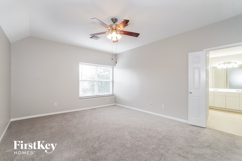 a bedroom with carpet and a ceiling fan