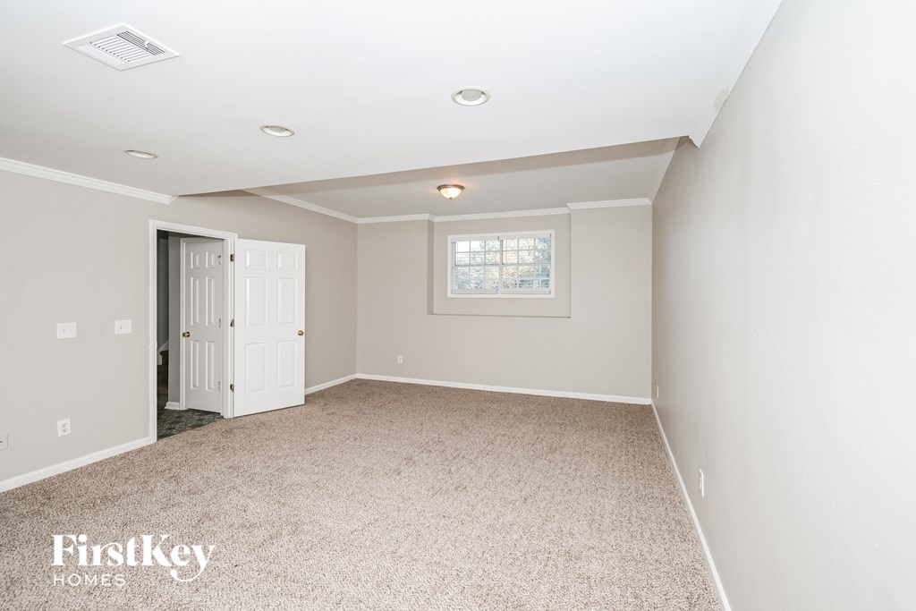 a white room with a white door and a carpeted floor
