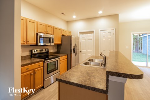a kitchen with granite counter tops and stainless steel appliances