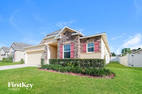 A house with a red window and a sign that says FirstKey Homes.
