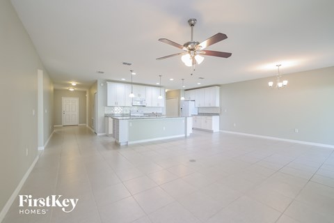 A spacious kitchen and living room with a FirstKey Homes logo.