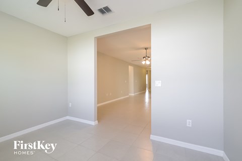 A spacious hallway with a fan and light fixture.