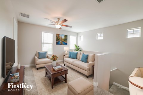 A living room with a brown coffee table and a beige couch.