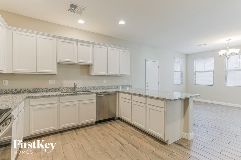 a kitchen with white cabinets and a counter top