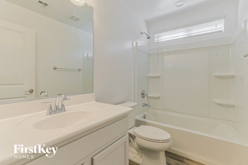 a bathroom with a sink toilet and a tub