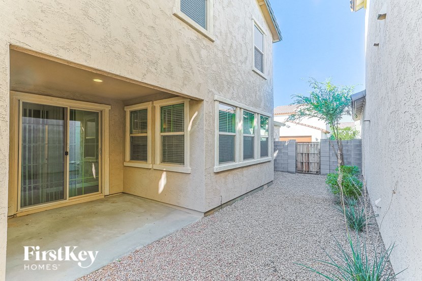 a patio outside of a house with glass doors and windows