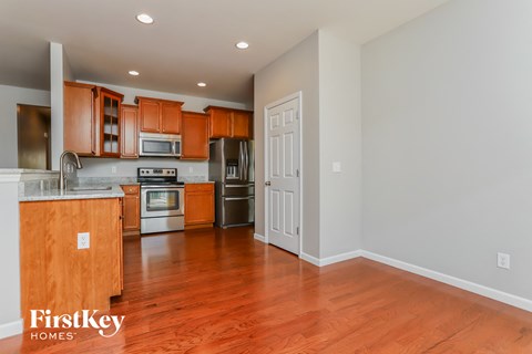 A kitchen with wooden cabinets and a wooden island.