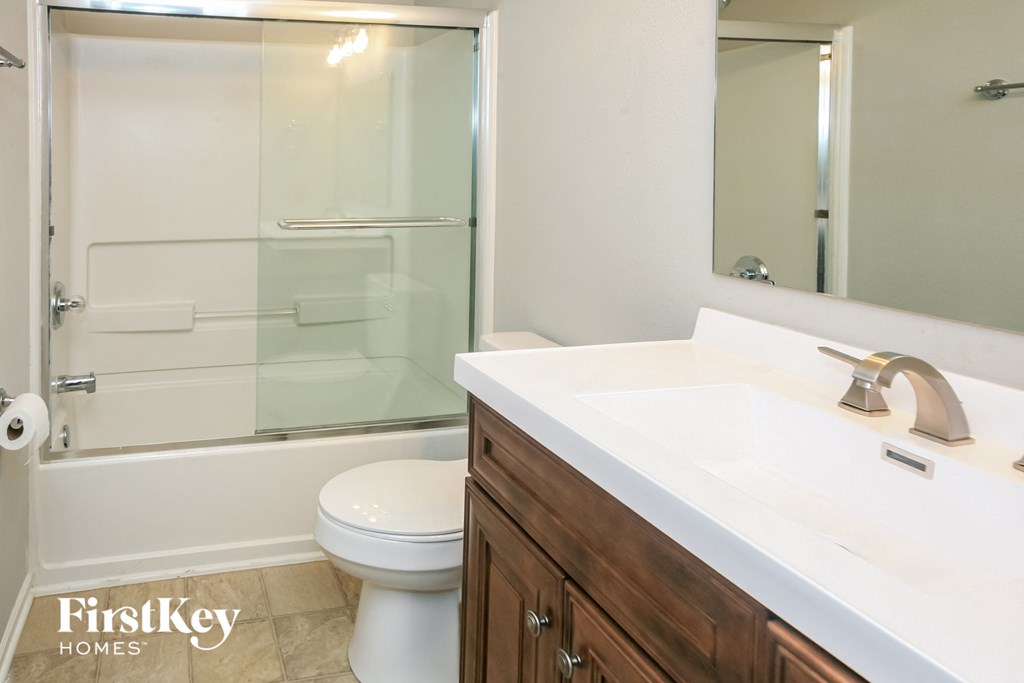 a bathroom with a toilet and a sink and a shower