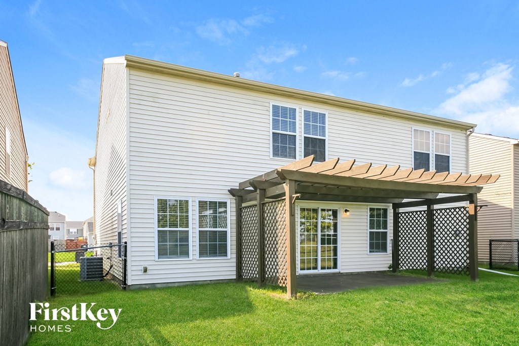 a white house with a porch and a grassy yard