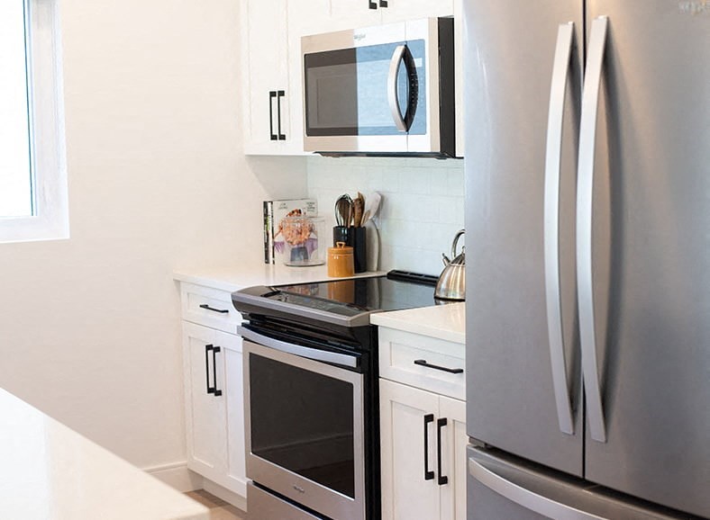 a kitchen with a stove and a refrigerator