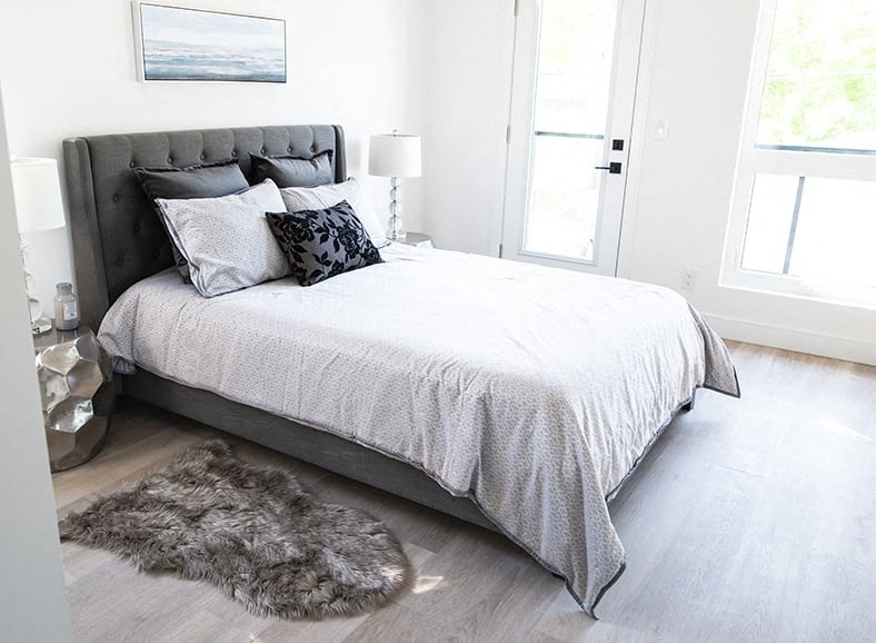 a bedroom with a bed and a rug