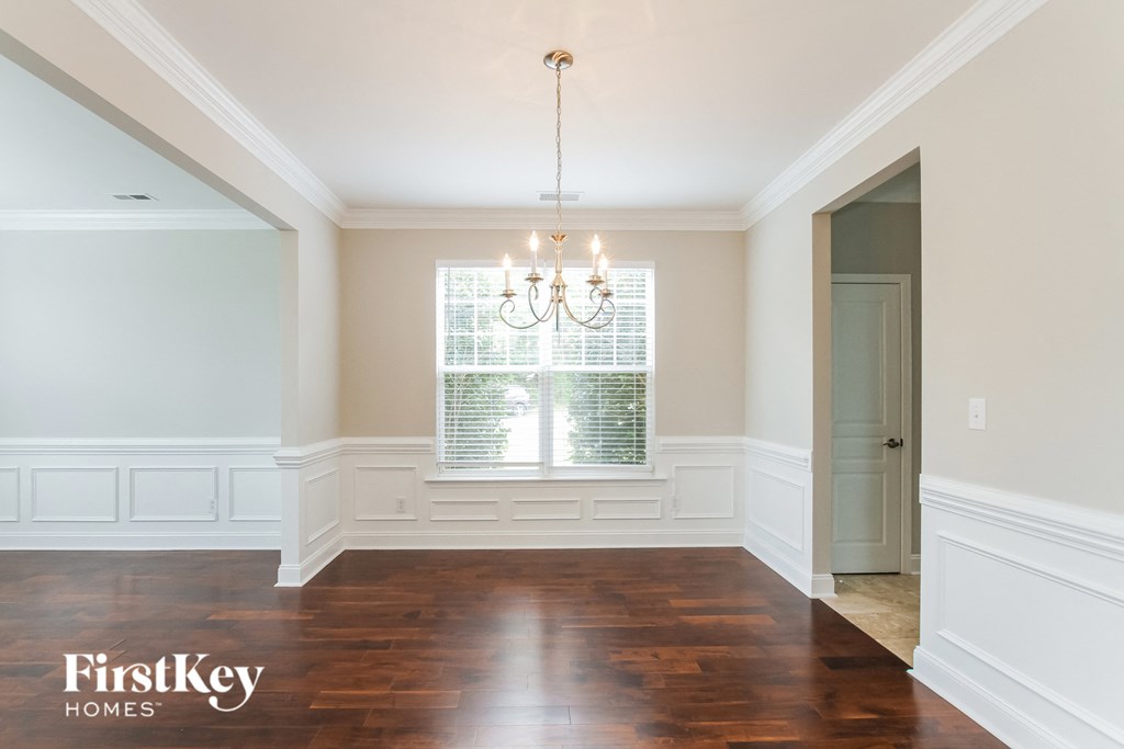 A room with wooden floors and a chandelier.