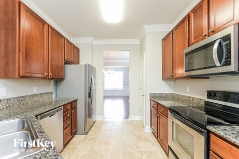 A kitchen with wooden cabinets and stainless steel appliances.